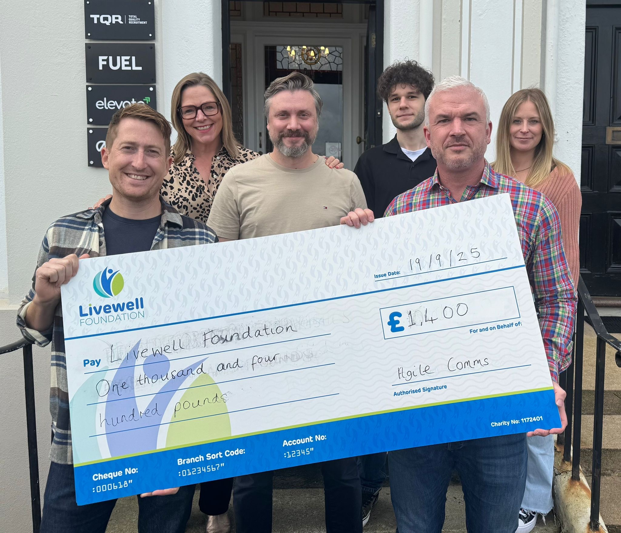 The Agile Comms team present trustees from The Livewell Foundation with a cheque for £1,400