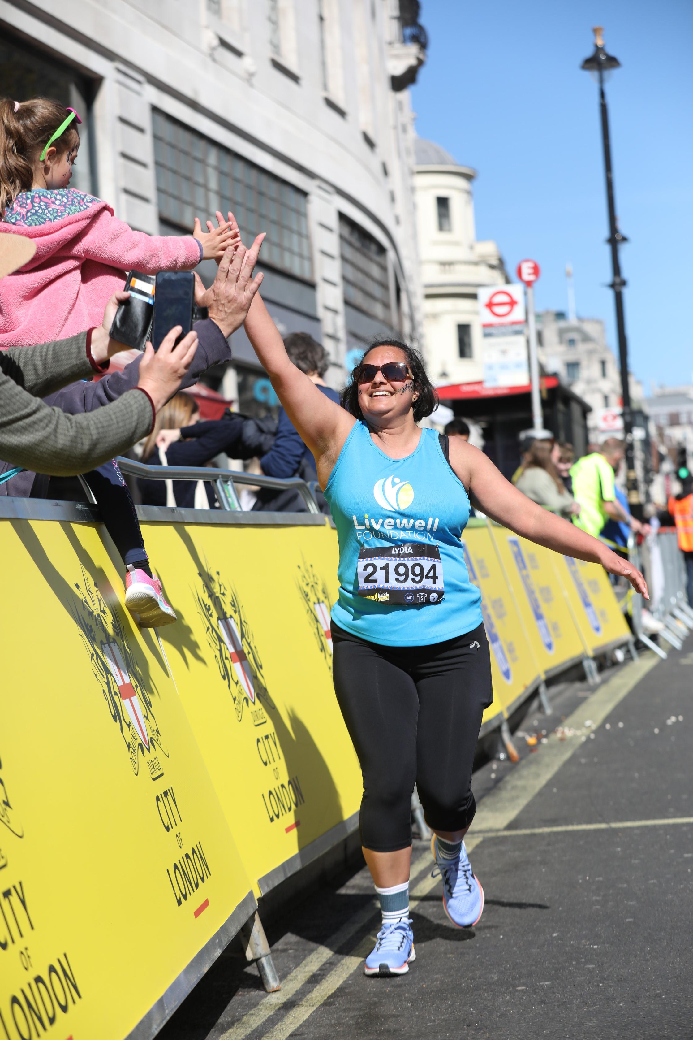 Livewell runner high fives daughter during LLHM